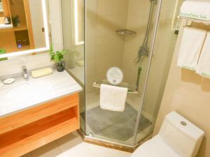 a bathroom with a shower with a toilet and a sink at GreenTree Inn Shangqiu Liangyuan District Suiyang Avenue Hotel in Shangqiu +13 photos