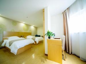 a hotel room with two beds and a desk and a room at GreenTree Inn Liaocheng Economic Development Zone Huitong Logistics Park Express Hotel in Liaocheng +11 photos