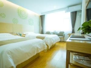 A bed or beds in a room at GreenTree Inn Baoding Xushui District Changcheng North Street Express Hotel