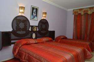 Postel nebo postele na pokoji v ubytování Hotel Amalay