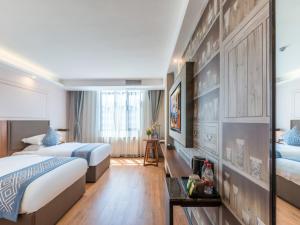 Postel nebo postele na pokoji v ubytování Gme Fuyang Guangming South Road Hotel