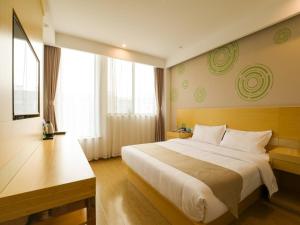 a bedroom with a large bed and a large window at GreenTree Inn Wuxi Rongchuang cultural Tourism City Nanquan Town Business Hotel in Wuxi +15 photos