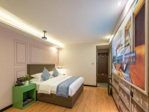 Postel nebo postele na pokoji v ubytování Gme Fuyang Guangming South Road Hotel