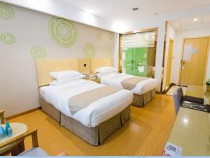 a hotel room with two beds and a desk at GreenTree Inn Maanshan East Railway Station Oushang Supermarket Business Hotel in Fengqiao