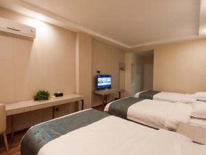 เตียงในห้องที่ Shell Huaibei City Xiangshan District Cuifeng Road Hotel