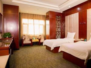 เตียงในห้องที่ GreenTree Inn Gansu Lanzhou Yantan High-tech Zone Nanhe Road Business Hotel