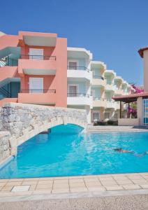 a swimming pool in front of a building at Dedalos Beach Hotel in Sfakaki