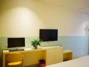 a room with a desk with a computer on it at Shell Taiyuan Xiaodian District Shanxi Hospital Hotel in Taiyuan