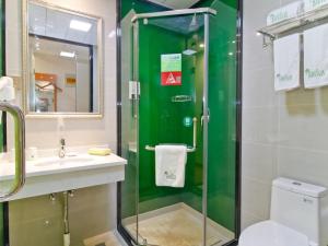 a bathroom with a shower and a sink and a toilet at Vatica Hefei Yaohai District Wangang Road Metro Station Hotel in Hefei +8 photos