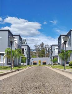 an empty street in front of white buildings at Las Toscas Apart in Curuzú Cuatiá