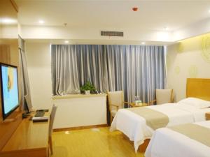 a hotel room with two beds and a flat screen tv at GreenTree Inn Bozhou Mengcheng District Red Star Macalline Business Hotel in Mengcheng