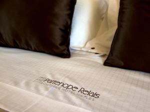 a close up of a bed with some pillows at Partenope Relais in Naples