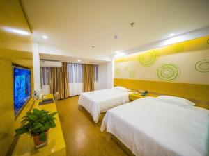 a hotel room with two beds and a flat screen tv at GreenTree Inn Chuzhou Langya Mountain Scenic Area Xijian Road Business Hotel in Chuzhou