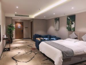 a bedroom with a large bed and a blue couch at GME Rizhao Jinan Road Sun Plaza Hotel in Rizhao +43 photos