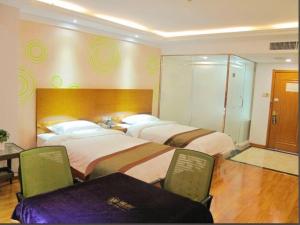 Voodi või voodid majutusasutuse GreenTree Inn Nei Monggol Autonomous Region Alxa Left banner Wealth Center Business Hotel toas