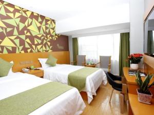 A bed or beds in a room at Vatica Hefei Silihe Road wen One hundred street Hotel