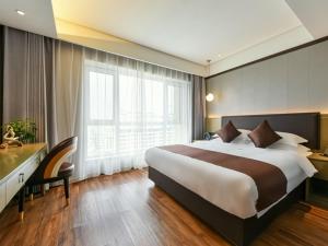 a bedroom with a large bed and a large window at GYA Langfang Art Avenue International Airport Hotel in Langfang +53 photos