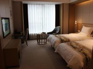 Postel nebo postele na pokoji v ubytování GreenTree Eastern Shaoxing Keqiao Jindizizaicheng Hotel