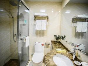 a bathroom with a shower and a toilet and a sink at GreenTree Inn Jiangsu Huai’an Hexia Acient Town Zhou Enlai Memorial Hall Express Hotel in Huai'an