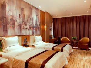 a hotel room with two beds and a room with at GreenTree Eastern Tianjin Wuqing Stadium Hotel in Tianjin