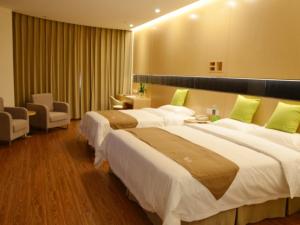 a hotel room with two large beds and avisor at Vatica Xuzhou Suining Bus Station Bayi West Road Hotel in Suining