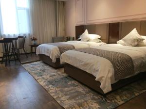Posteľ alebo postele v izbe v ubytovaní GME Huainan Tianjiaan District Chaoyang East Road Hotel