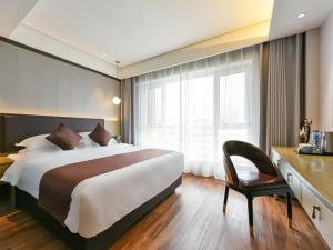 Postelja oz. postelje v sobi nastanitve GYA Langfang Art Avenue International Airport Hotel