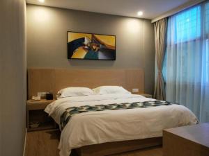 a bedroom with a large bed and a window at Shell Shanghai New International Expo Center Fanghua Road Metro Station Hotel in Shanghai