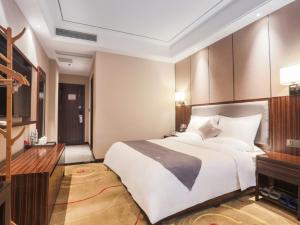 A bed or beds in a room at GreenTree Eastern Ganzhou City Zhanggong DistrictEight one four Avenue bus station Hotel