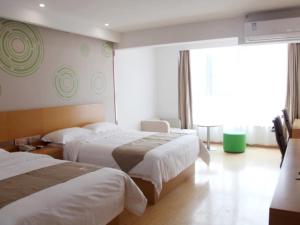 Ένα ή περισσότερα κρεβάτια σε δωμάτιο στο GreenTree Inn Jinan Licheng District Fenghuang Road High-speed Railway East Station Express Hotel