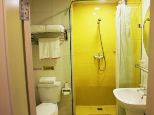 a bathroom with a toilet and a sink and a shower at Shell Xinyu City Railway Station Plaza Hotel in Xinyu