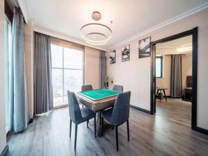 a room with a ping pong table and chairs at GreenTree Alliance JiangXi ShangRao YiYang County ZhiMin Aveune YingBin Avenue Hotel in Yiyang