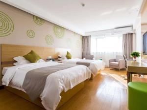 En eller flere senger på et rom på GreenTree Inn Anhui Suzhou city Si District Bianhe Avenue Business Hotel