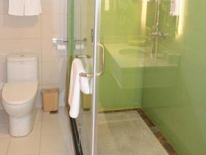 a bathroom with a shower with a toilet and a sink at GreenTree Inn Tangshan Lubei District Hancheng Likang Hospital Express Hotel in Tangshan +8 photos