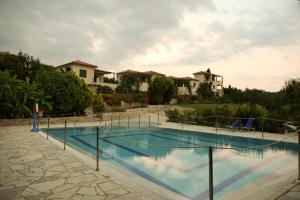a swimming pool with a net in front of a house at Il Villaggio in Chrani