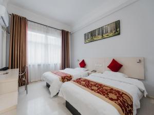 Ένα ή περισσότερα κρεβάτια σε δωμάτιο στο Shell Luoyang Lijingmen Mingtang Hotel