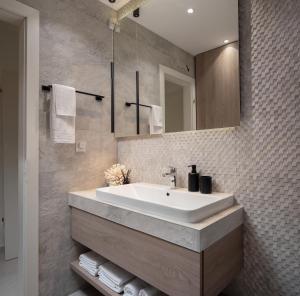 a bathroom with a white sink and a mirror at Villa VinSun in Vinišće +31 photos