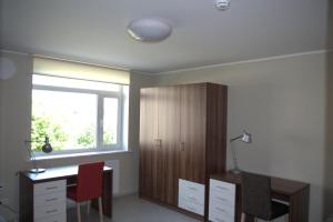 a bedroom with a desk and a window and a desk and chair at Hiiumaa Ametikooli Accommodation in Suuremõisa