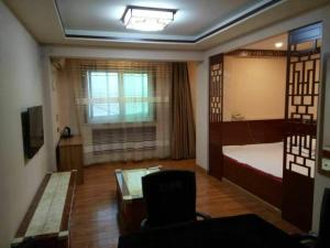 Habitación con dormitorio con cama y ventana en Shell Zhaozhong Ancient Street, Jinzhong County Railway Station Hotel en Qixian