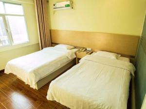 Krevet ili kreveti u jedinici u okviru objekta GreenTree Inn Jiangsu Nantong Haimen Bus Statian Shell Hotel