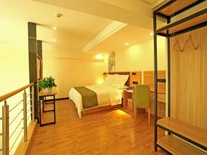 A bed or beds in a room at GreenTree Inn Anlong County Zhaodi Hotel