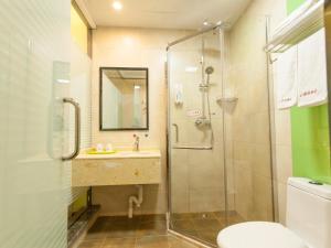 a bathroom with a shower and a sink and a toilet at Shell Hefei Economic Development Zone Hong Kong and Macao Square Hotel in Hefei