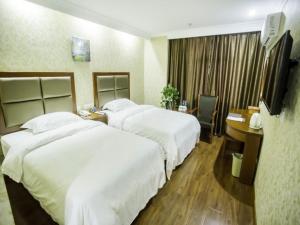 a hotel room with two beds and a desk at GreenTree Inn Anhui Bozhou Agricultural Trade City Express Hotel in Bozhou +31 photos