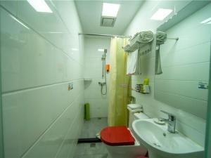 bagno con servizi igienici rossi e lavandino di Shell Dali City Dali Ancient Town South Gate Hotel a Dali