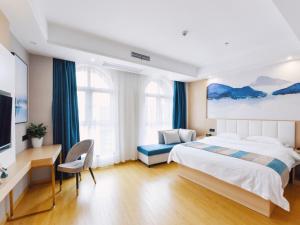 a bedroom with a bed and a desk and a tv at VX Wuxi Jiangyin High-tech Zone Panlongshan Park Hotel in Jiangyin