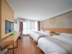 Lova arba lovos apgyvendinimo įstaigoje GreenTree Inn Yancheng National Fitness Center Express Hotel