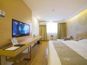 a hotel room with two beds and a flat screen tv at GreenTree Inn Beijing Tongzhou District Xuxinzhuang Subway Station Express Hotel in Beijing