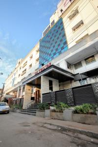 a hotel building with a car parked in front of it at Taj Tristar in Hyderabad