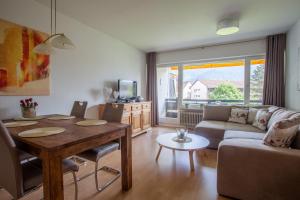 een woonkamer met een tafel en een bank bij Alpenzauber Whg.25 in Garmisch-Partenkirchen