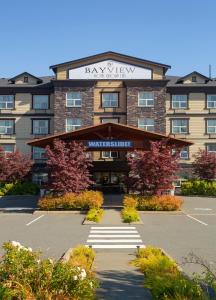 a hotel with a sign on the front of it at Bayview Hotel in Courtenay